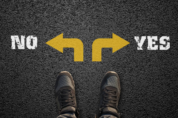 istock Choosing between yes or no with shoes on the asphalt ground 1307451034