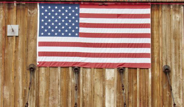 istock American flag hanging on a wood wall 1307452692