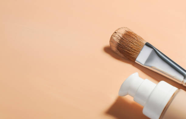 istock Glass bottle with liquid foundation with cosmetic makeup brush, Makeup foundation background, Fluid foundation base for nude skin 1307455208