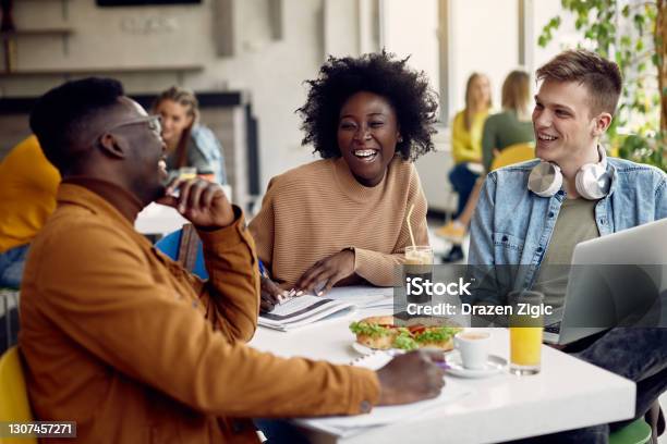 Cheerful Group Of College Students Having Fun On Lunch Break In Cafeteria Stock Photo - Download Image Now
