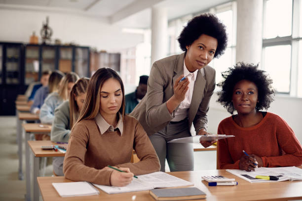 istock Black female professor talking to students during lecture in the classroom. 1307457294