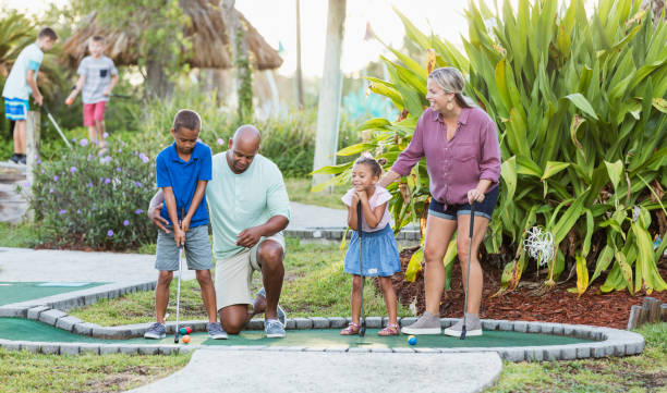 istock Interracial family, two children playing miniature golf 1307457724