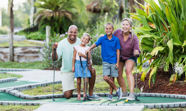 istock Interracial family, two children playing miniature golf 1307457725