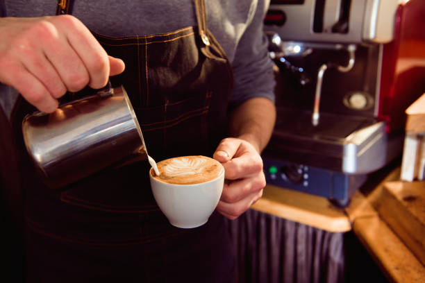 istock Coffee Latte Barista making pattern in a cup of coffee shop. 1307457765