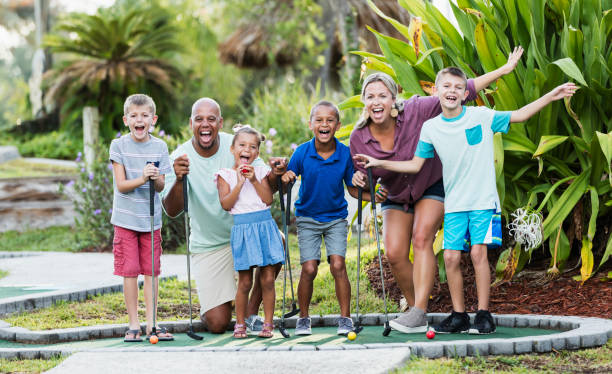 istock Friends and family on miniature golf course 1307457771