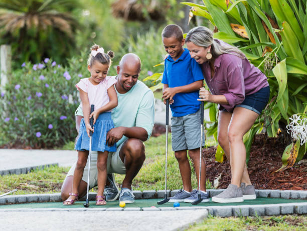 istock Interracial family, two children playing miniature golf 1307457791