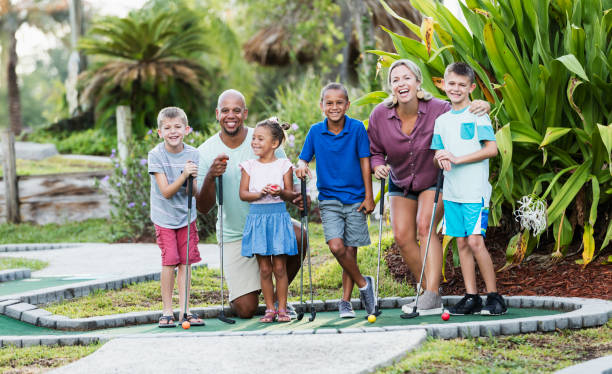 istock Friends and family on miniature golf course 1307457818
