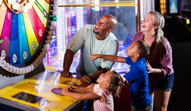 istock Interracial family, two children playing arcade game 1307457837