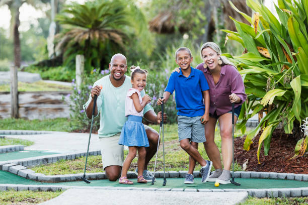 istock Interracial family, two children playing miniature golf 1307457838