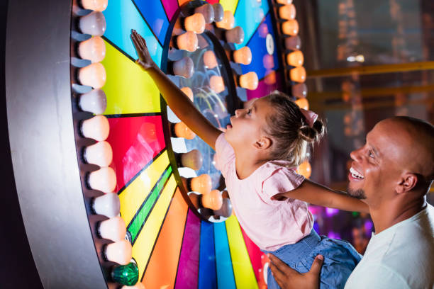 istock Mixed race girl with father at amusement arcade 1307457852