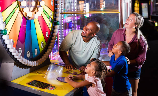 istock Interracial family, two children playing arcade game 1307457865