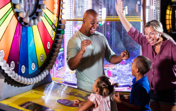 istock Interracial family, two children winning an arcade game 1307457903