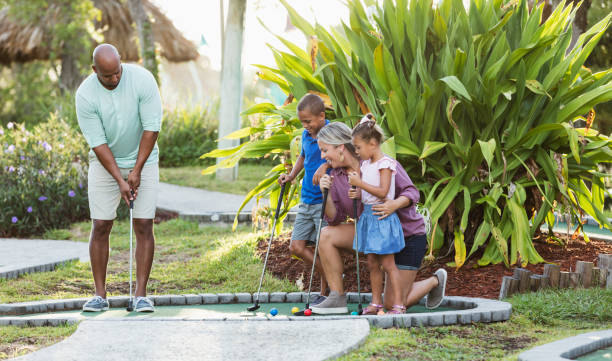 istock Interracial family, two children playing miniature golf 1307457925