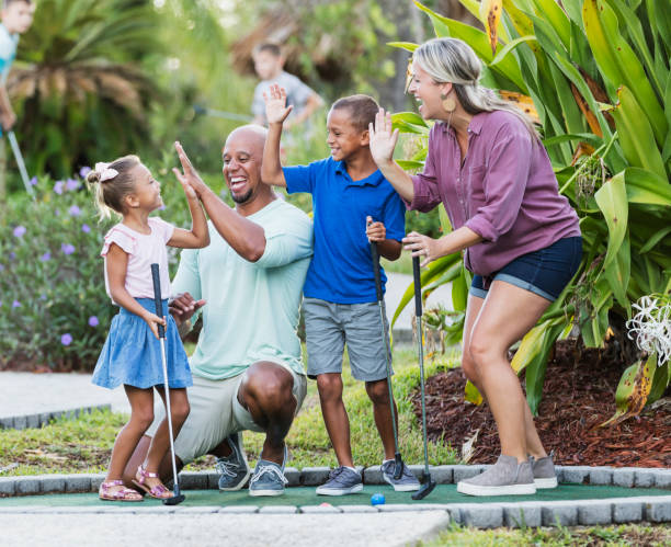 istock Interracial family, two children playing miniature golf 1307457937