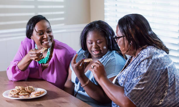 istock Three generations, girl with downs, eating cookies 1307458596