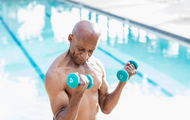 istock Senior African-American man lifting hand weights 1307459063