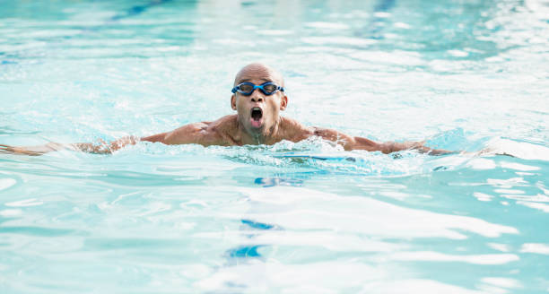 istock Senior African-American man swimming 1307459140