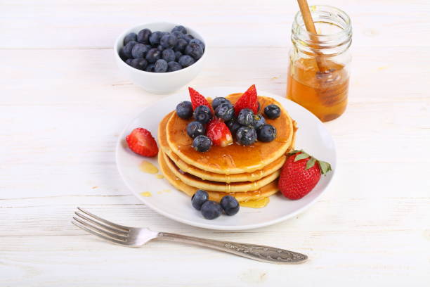 istock Still life with pancakes, berries and honey 1307460058