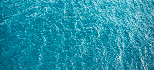 Blue turquoise sea water background. Aerial view.