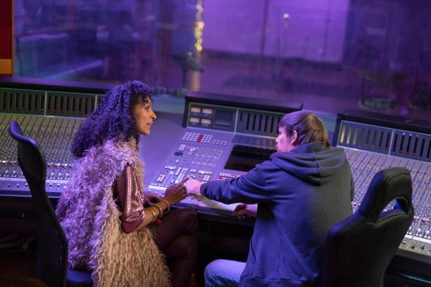 istock Woman talking with composer in recording studio 1307464328