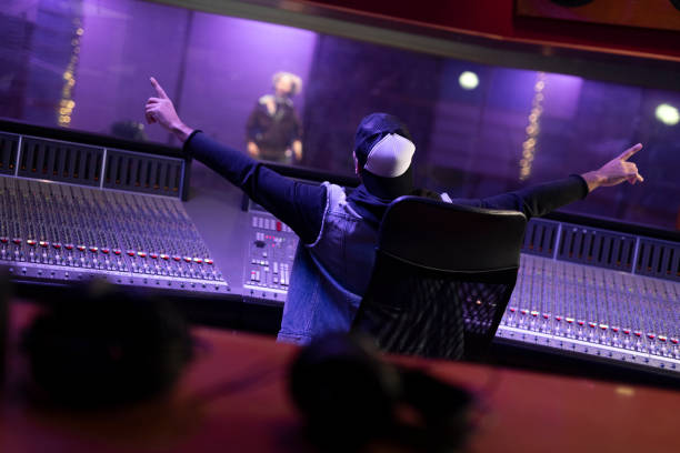 istock Man raising hands while listening to music 1307464403