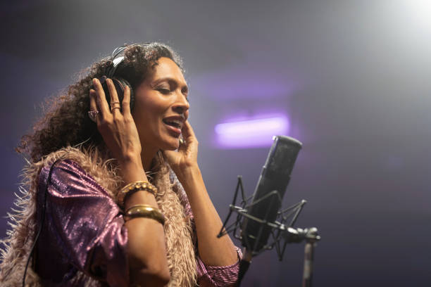 istock Mature woman singing in recording studio 1307464417