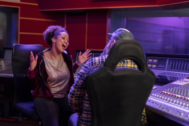 istock Female singer talking with composer in recording studio 1307464477
