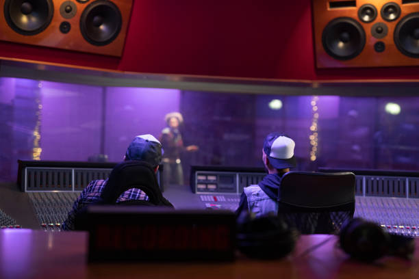 istock Men listening to music in recording studio 1307464511
