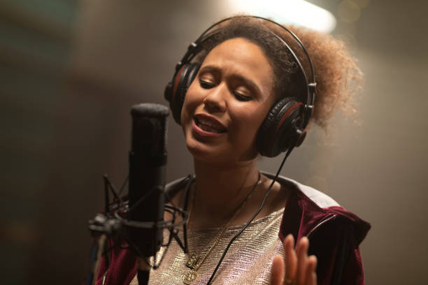 istock Female singer singing in recording studio 1307464512