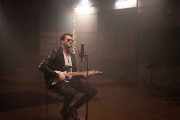 istock Male singer playing guitar 1307464513