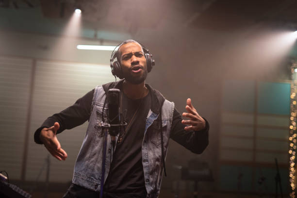 istock Male singer singing in recording studio 1307465060