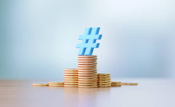 Blue Hashtag Symbol Sitting On Coin Stacks Before Defocused Background