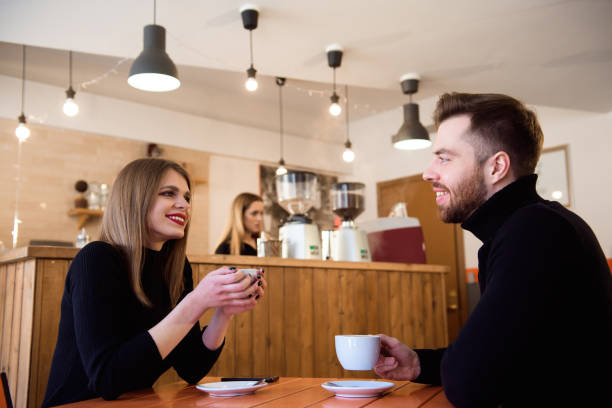 istock Young couple talking in a coffee shop 1307466258