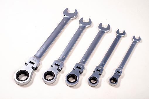 Open-end ratchet wrenches. Accessories for mechanics carrying out repairs in the household. Light background.