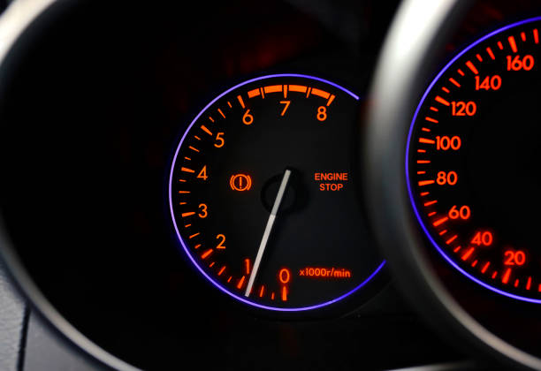 istock Car dashboard with stop engine sign. Car malfunction, engine maintenance is required. Closeup illuminated car dashboard with selective focus 1307468709