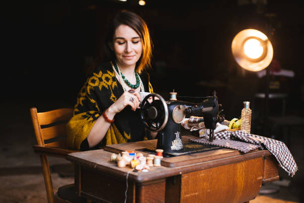 istock Confident woman uses a antique sewing machine 1307468785