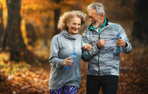 istock Mature couple jogging in a forest. 1307470407