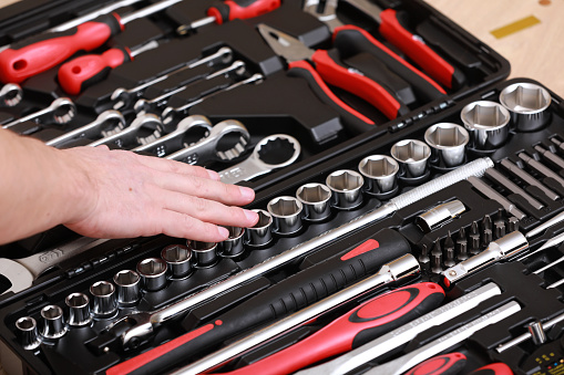 Customers or worker, builder, repairman, handyman, at the store chooses wrench, nuts, instrument, tools. Display of tools shop marketing for home and auto repair.