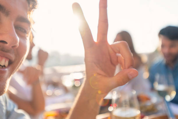 istock Happy man looking at the camera making a peace sign. 1307472158