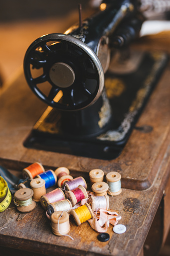 Vintage hand sewing machine. Black sewing machine on a wooden stand.