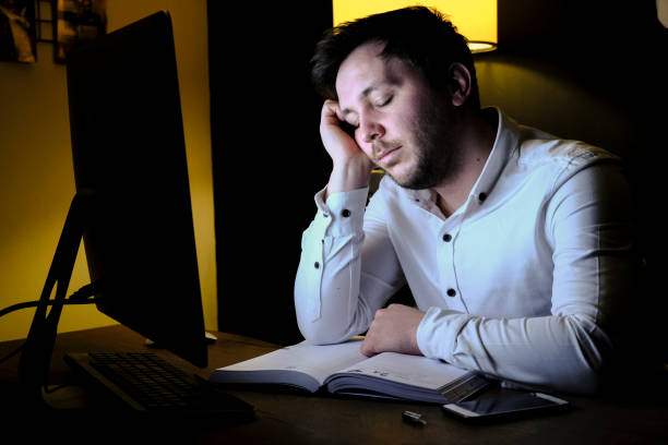 istock Tired Young Business Man Working With Computer, Fall Asleep 1307474109