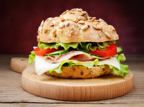 istock Sandwich with roast ham, cheese, lettuce, cucumber and pomdoro, closeup. 1307475830