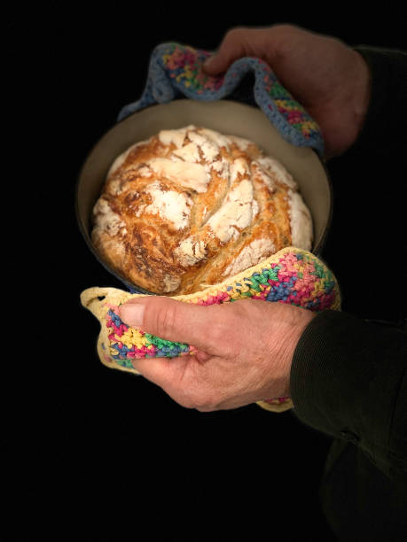 istock Man's Hands Holding Fresh Loaf Homemade Bread 1307480580