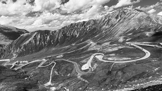 Mountain asphalt road serpentine. Winding Grossglockner High Alpine Road with Edelweissspitze on background, Austria. Black and white image.