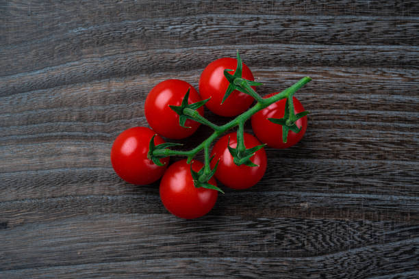 istock A bunch of cherry tomatoes on a wooden table 1307481318