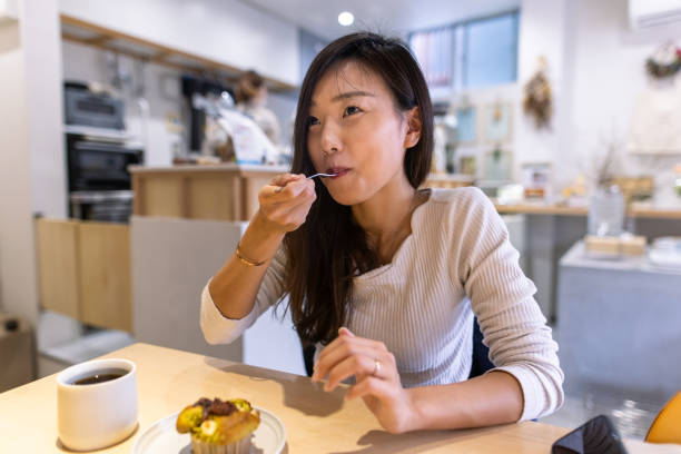 istock Young woman enjoying tea time 1307482558