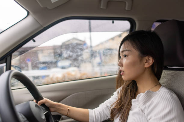 istock Young woman driving a car 1307482601