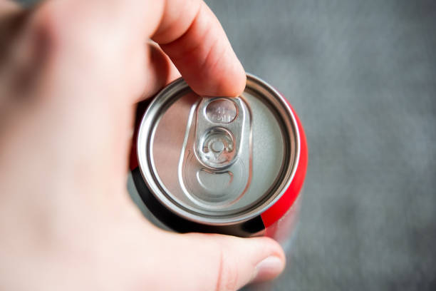 Opening Beverage Can Pulling the tab of a beverage can with a left male hand. Opening a refreshment drink like cola or energydrink after a hard day. energy drinks stock pictures, royalty-free photos & images