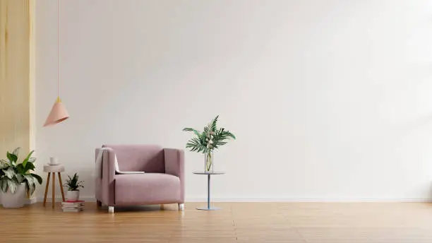 Photo of Modern minimalist interior with an armchair on empty white wall background.