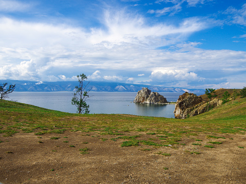 Lake Baikal on a clear sunny day, travel concept. Shaman Rock, Island of Olkhon, Lake Baikal, Russia on a Summer Day. Lake Baikal is a huge ancient lake in the Siberian mountains north of the Mongolian border. Baikal is considered the deepest lake in the world.